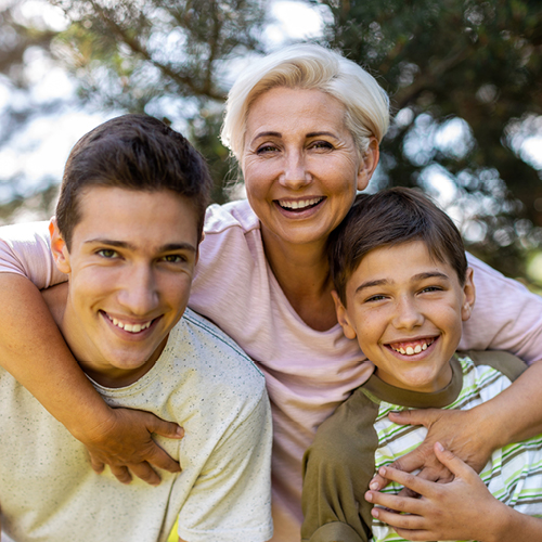 Loving mom with her arms around her sons; one teenage and one pre-teen. 